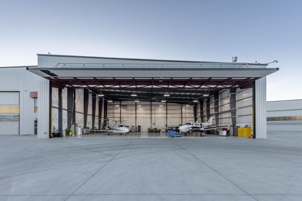 airplane hanger with two private planes
