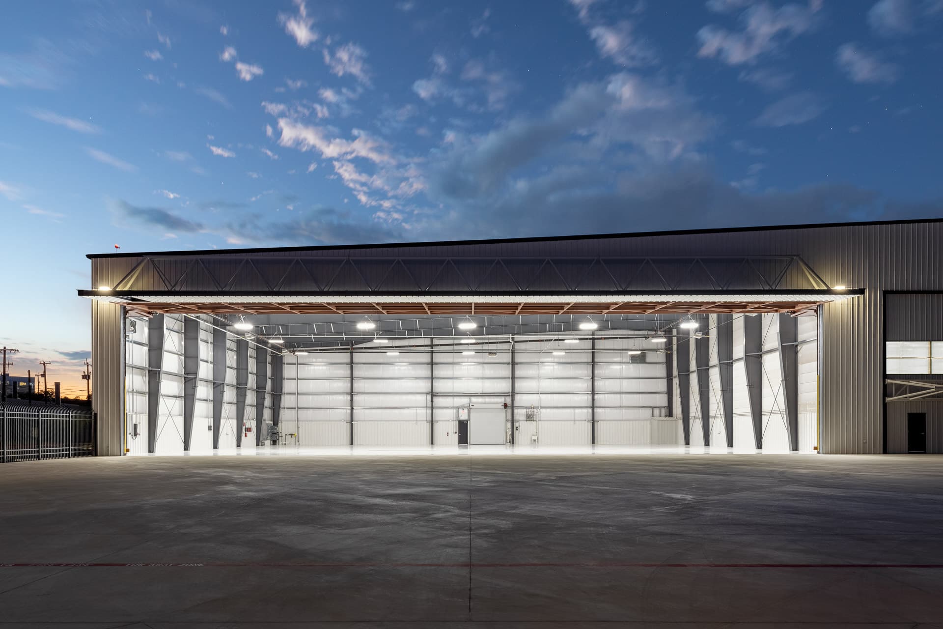 view of the interior of an empty airplane hanger in San Antonio at dusk